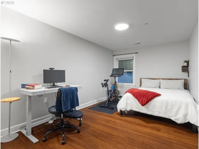 a bedroom with a bed and a desk
