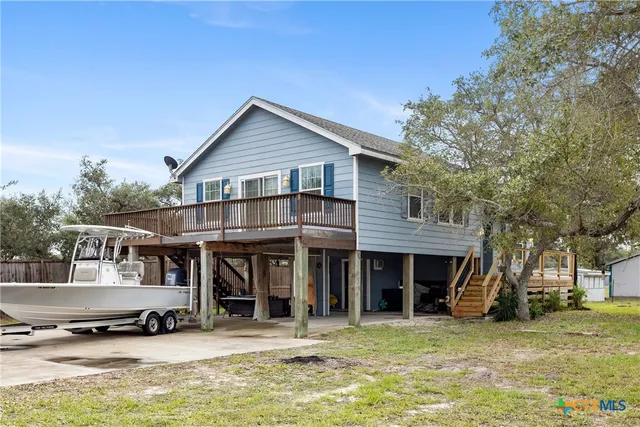 a view of a house with a yard and balcony
