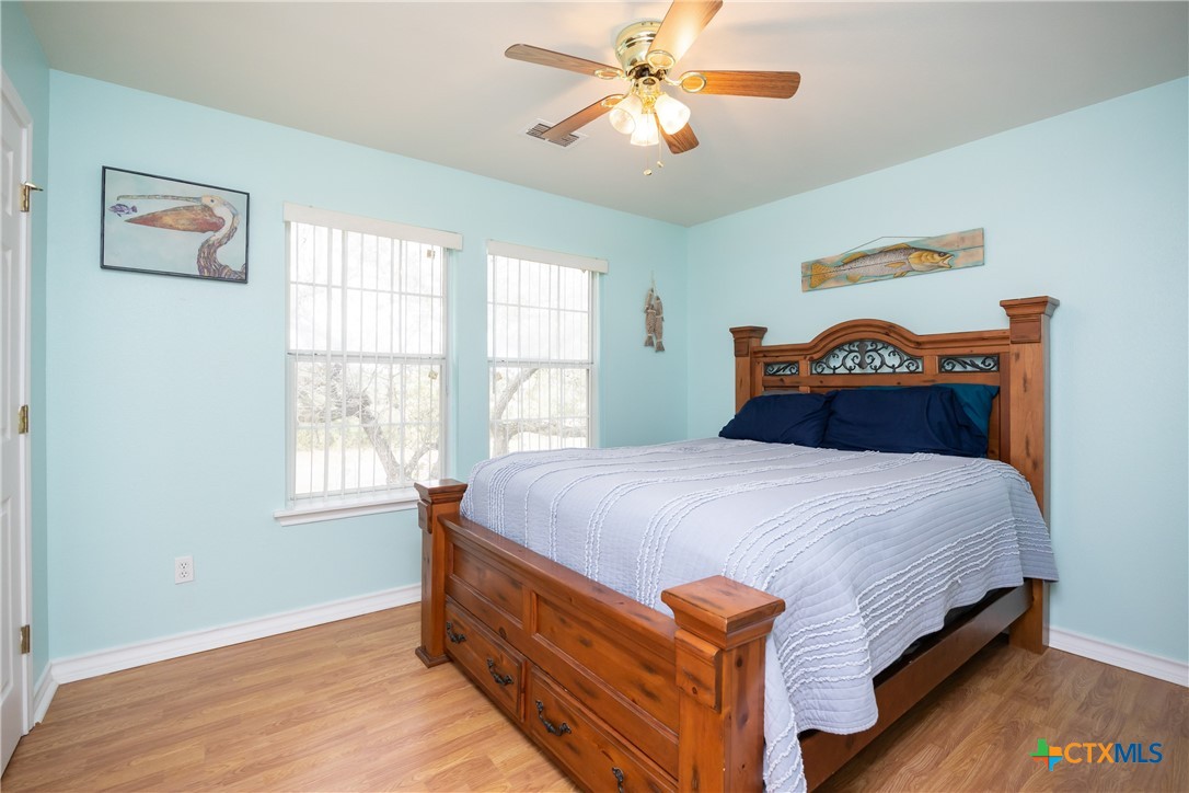 118 South Walker Road Aransas Pass, TX 78336 - Photo 11 of 20 a bed sitting in a bedroom next to a window