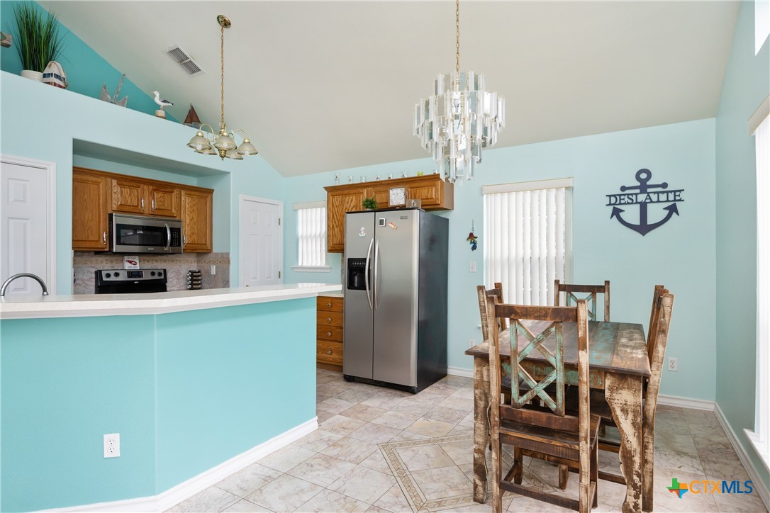 118 South Walker Road Aransas Pass, TX 78336 - Photo 4 of 20 a view of a dining room with furniture window and wooden floor