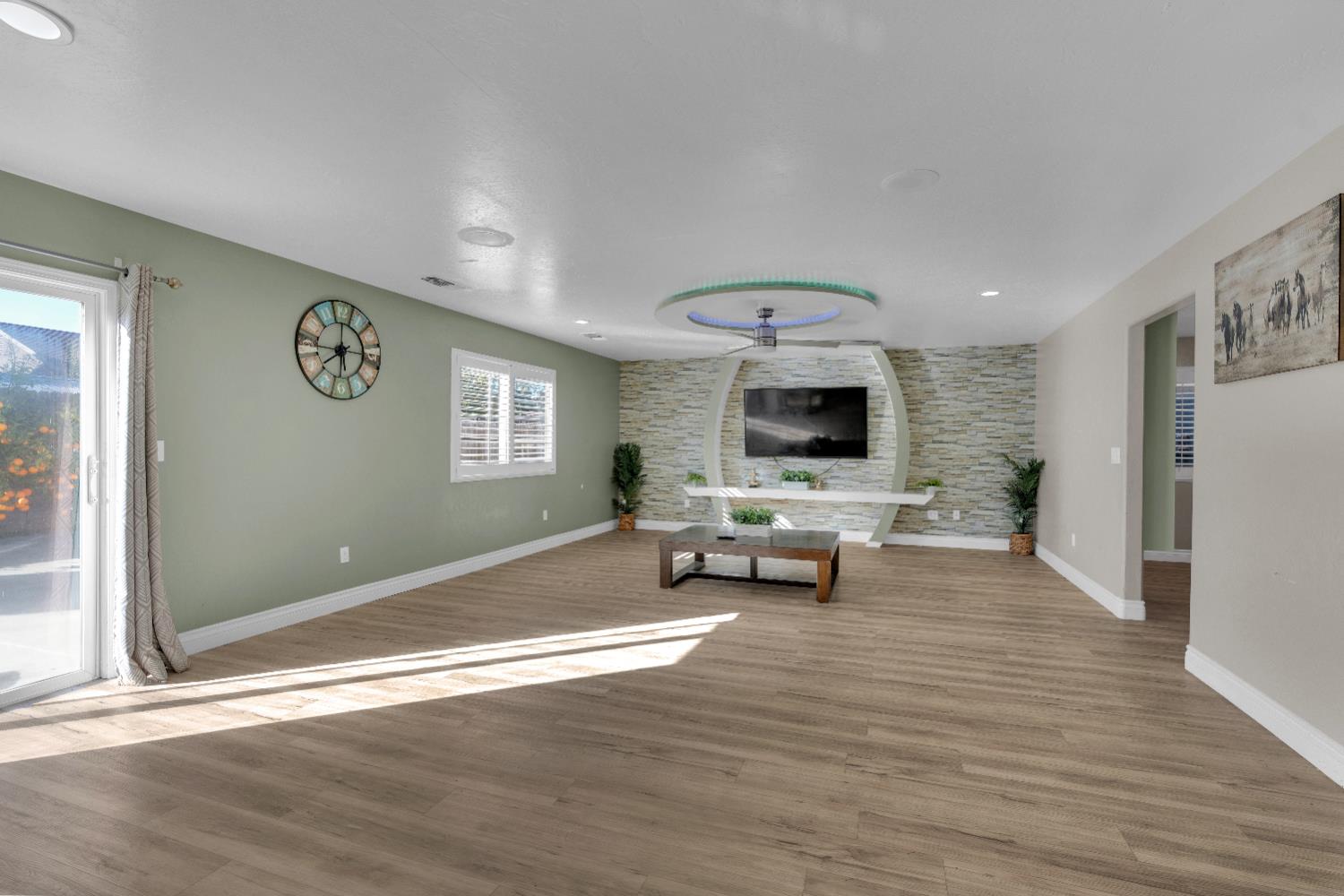 4729 North Rumi Avenue Fresno, CA 93723 - Photo 17 of 35 a living room with furniture and a flat screen tv
