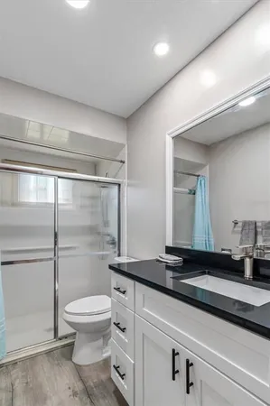 a bathroom with a toilet a sink and shower