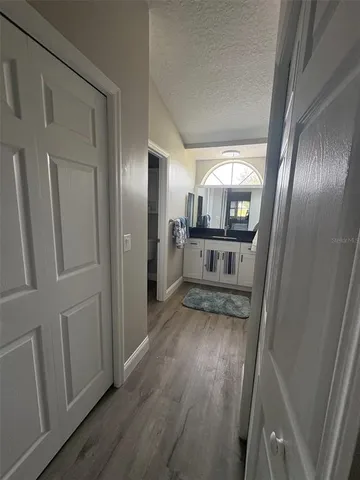 a view of a hallway with wooden floor fireplace and staircase