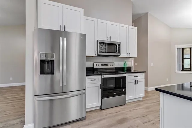 a kitchen with stainless steel appliances a refrigerator stove and microwave