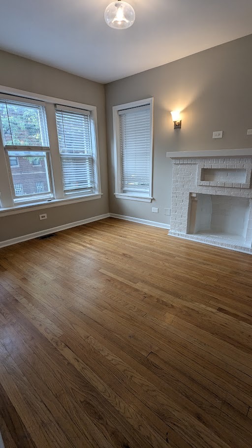 3745 West Argyle Street, Unit 1 Chicago, IL 60625 - Photo 12 of 35 a view of an empty room with window and wooden floor