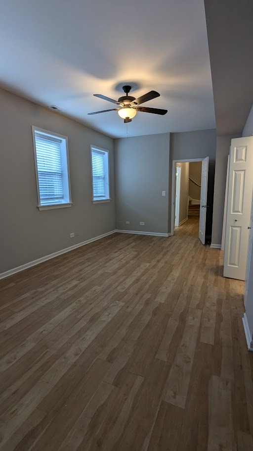3745 West Argyle Street, Unit 1 Chicago, IL 60625 - Photo 21 of 35 a view of an empty room with window and wooden floor