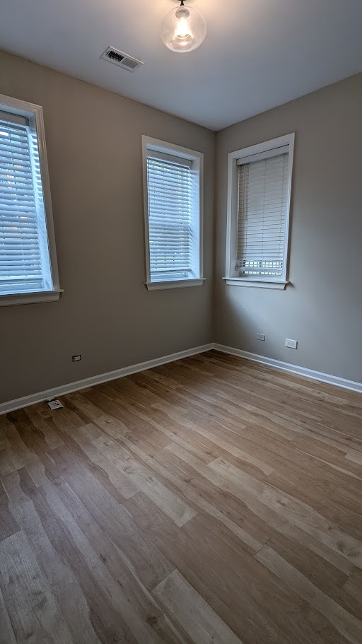 3745 West Argyle Street, Unit 1 Chicago, IL 60625 - Photo 27 of 35 a view of an empty room with wooden floor and a window