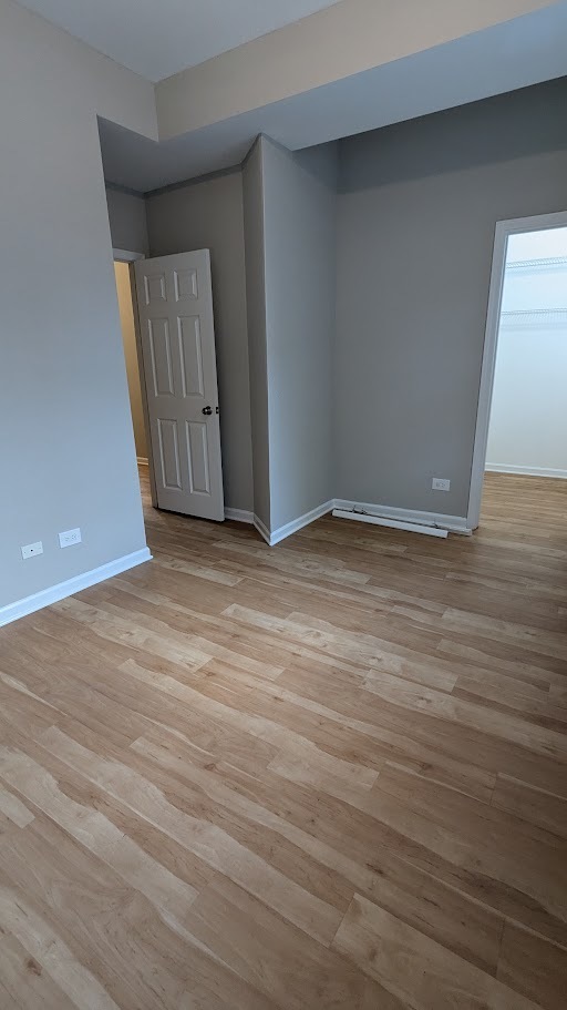 3745 West Argyle Street, Unit 1 Chicago, IL 60625 - Photo 29 of 35 a view of an empty room with wooden floor and a window