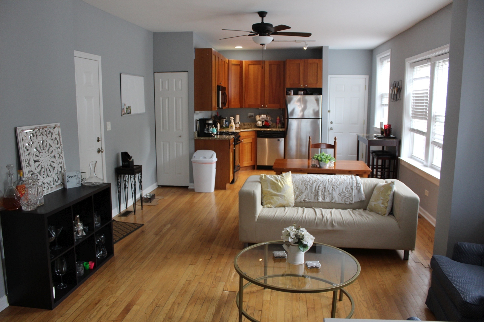 3745 West Argyle Street, Unit 1 Chicago, IL 60625 - Photo 3 of 35 a living room with furniture ceiling fan and a wooden floor