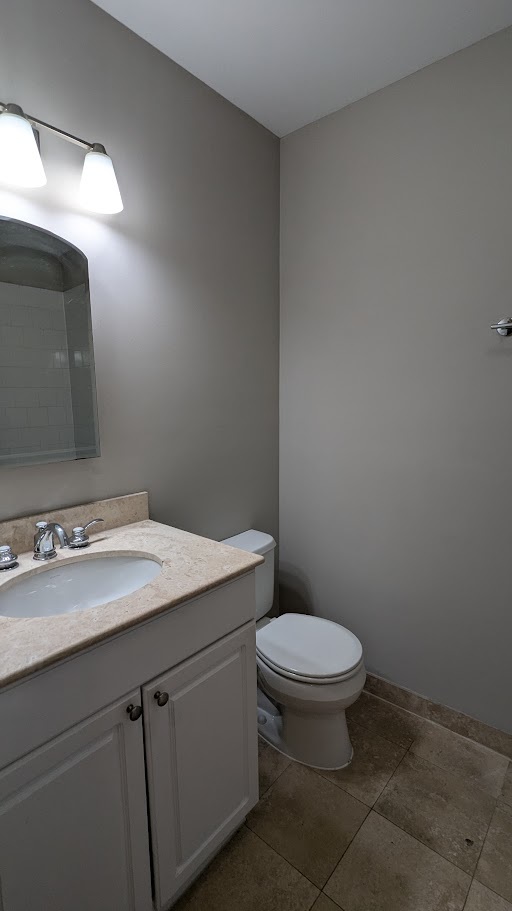 3745 West Argyle Street, Unit 1 Chicago, IL 60625 - Photo 32 of 35 a bathroom with a granite countertop toilet and sink