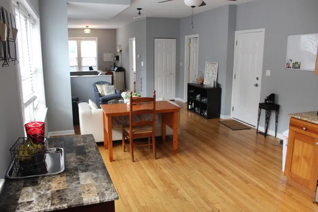 a dining room with furniture and wooden floor