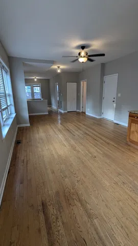 a view of a livingroom with a ceiling fan and window