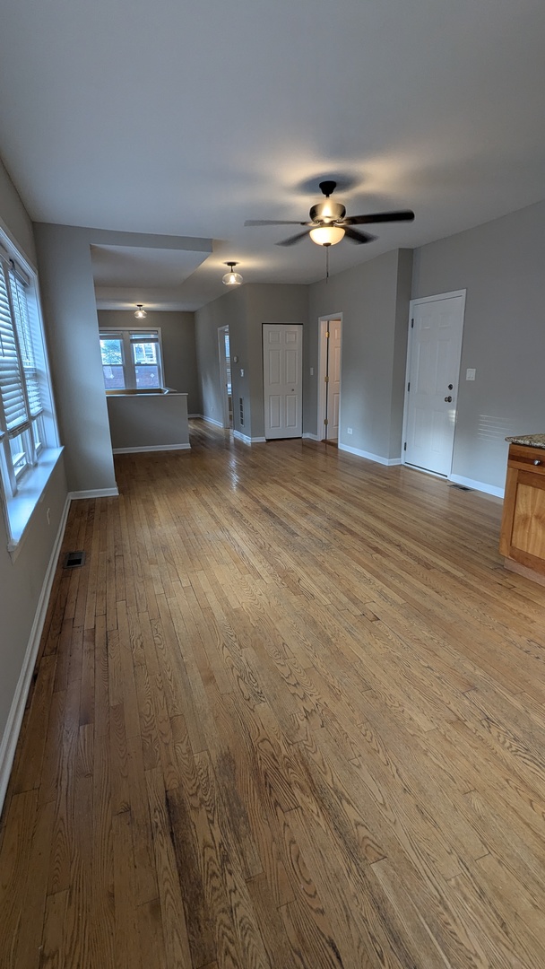 3745 West Argyle Street, Unit 1 Chicago, IL 60625 - Photo 6 of 35 a view of a livingroom with a ceiling fan and window