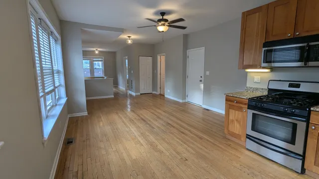 a kitchen with stainless steel appliances granite countertop a stove a sink and a refrigerator