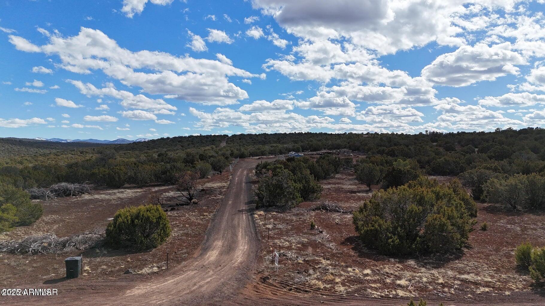71 North 8225th, Unit 202 Show Low, AZ 85901 - Photo 6 of 13 a view of a dry yard with wooden fence