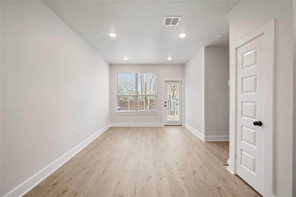 1218 Chestnut Court, Unit 2 Runaway Bay, TX 76426 - Photo 11 of 26 wooden floor in an empty room with a window
