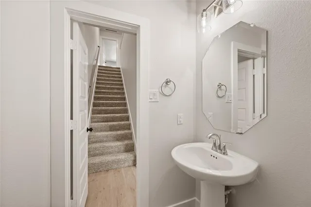 a bathroom with a sink a mirror and shower
