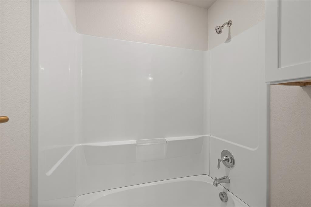 1218 Chestnut Court, Unit 2 Runaway Bay, TX 76426 - Photo 19 of 26 a close up of a bathtub