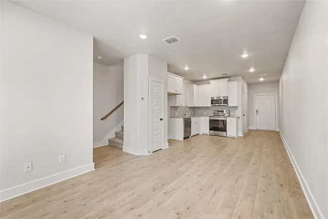 a view of kitchen with refrigerator stove microwave and cabinets