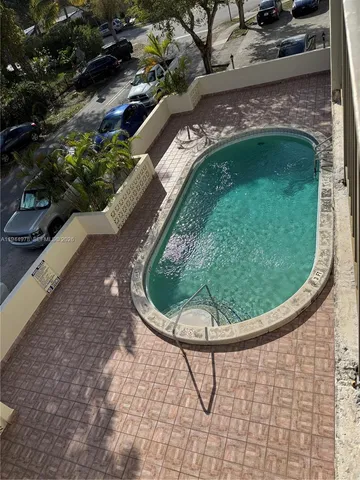 a view of a swimming pool with a yard