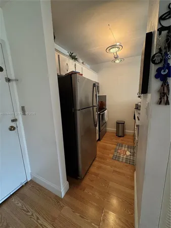 a view of a storage and utility room with wooden floor