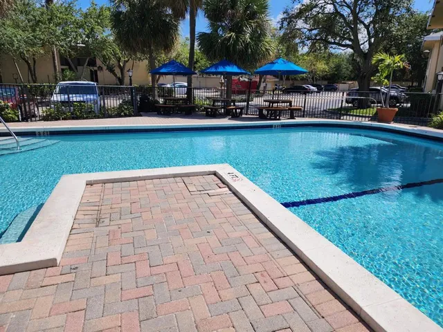 a patio with a table and chairs under an umbrella