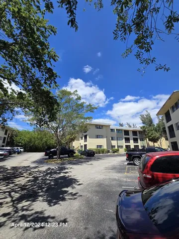 a car parked in front of a white house