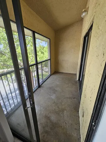a view of a hallway with wooden floor and stairs