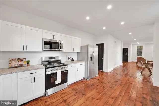 a view of a living room and hardwood floor