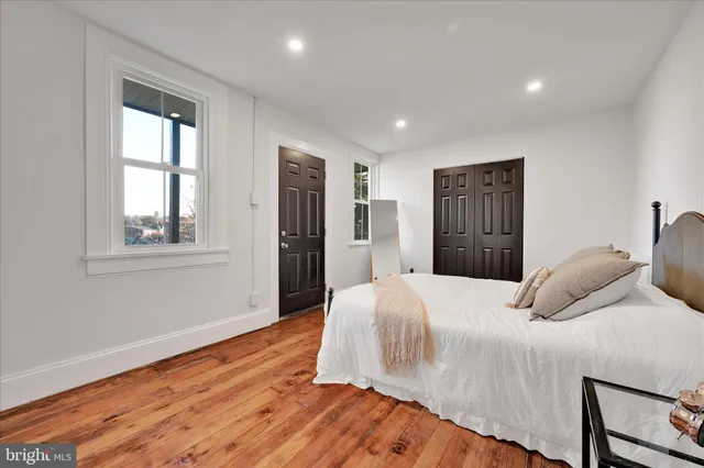 a bedroom with a bed and wooden floor