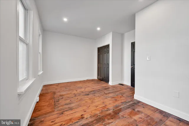 a view of an empty room with windows