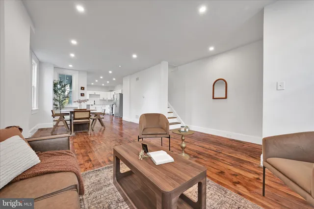 a view of a workspace with furniture and wooden floor