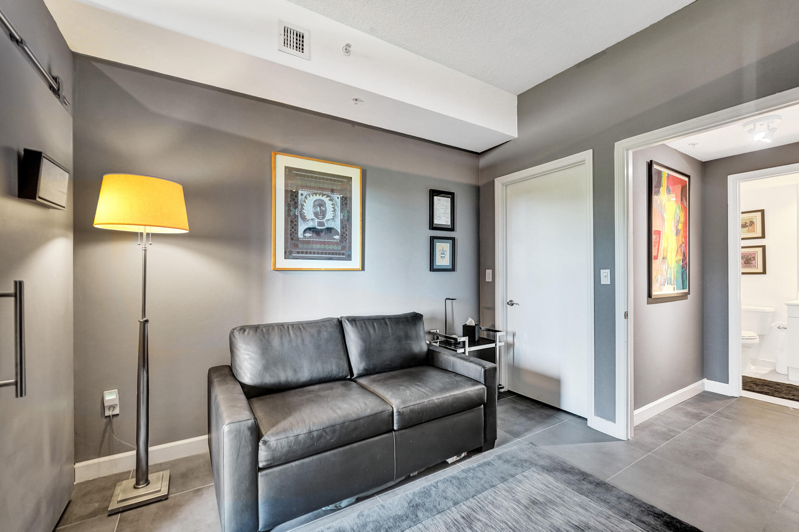 2301 Wilton Drive, Unit R309 Wilton Manors, FL 33305 - Photo 23 of 53 a living room with furniture and a lamp