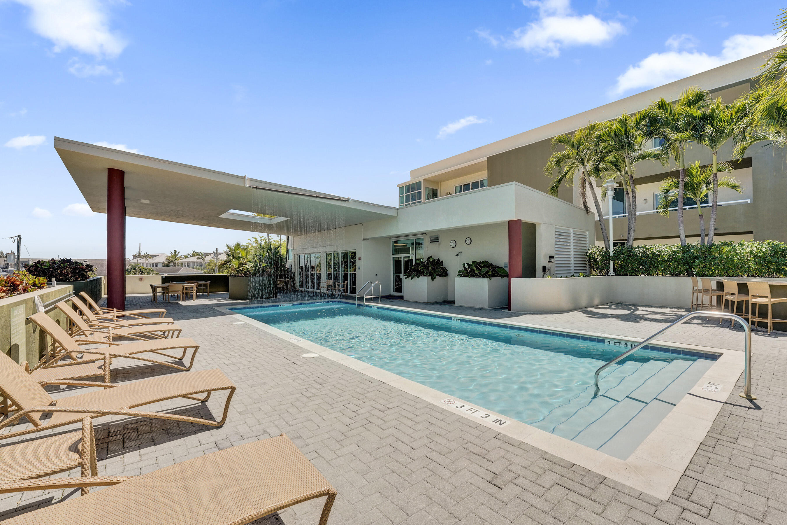2301 Wilton Drive, Unit R309 Wilton Manors, FL 33305 - Photo 43 of 53 a view of a patio with couches and chairs under an umbrella