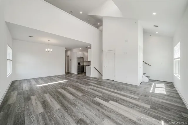 a view of an empty room and wooden floor