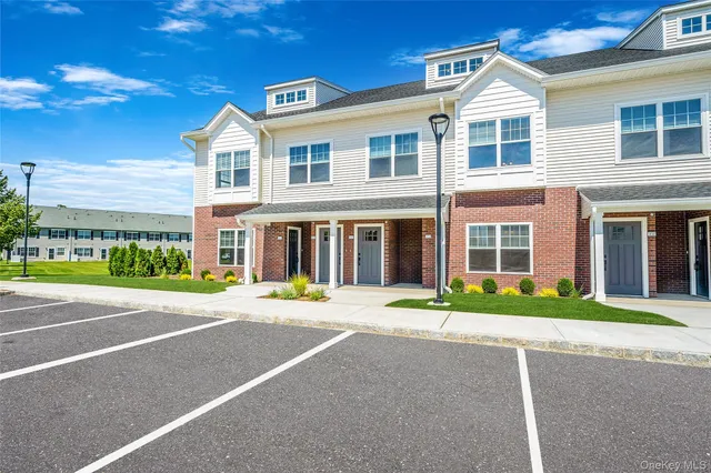 a front view of a building with a garden