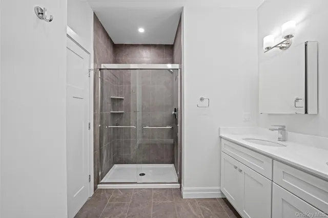 a bathroom with a shower sink and mirror