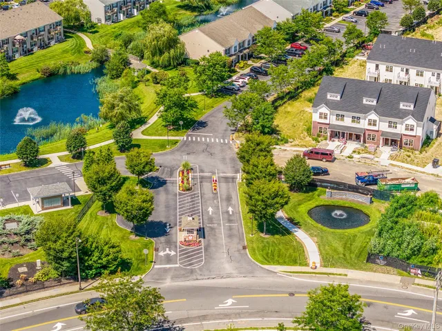 an aerial view of residential houses with outdoor space and swimming pool