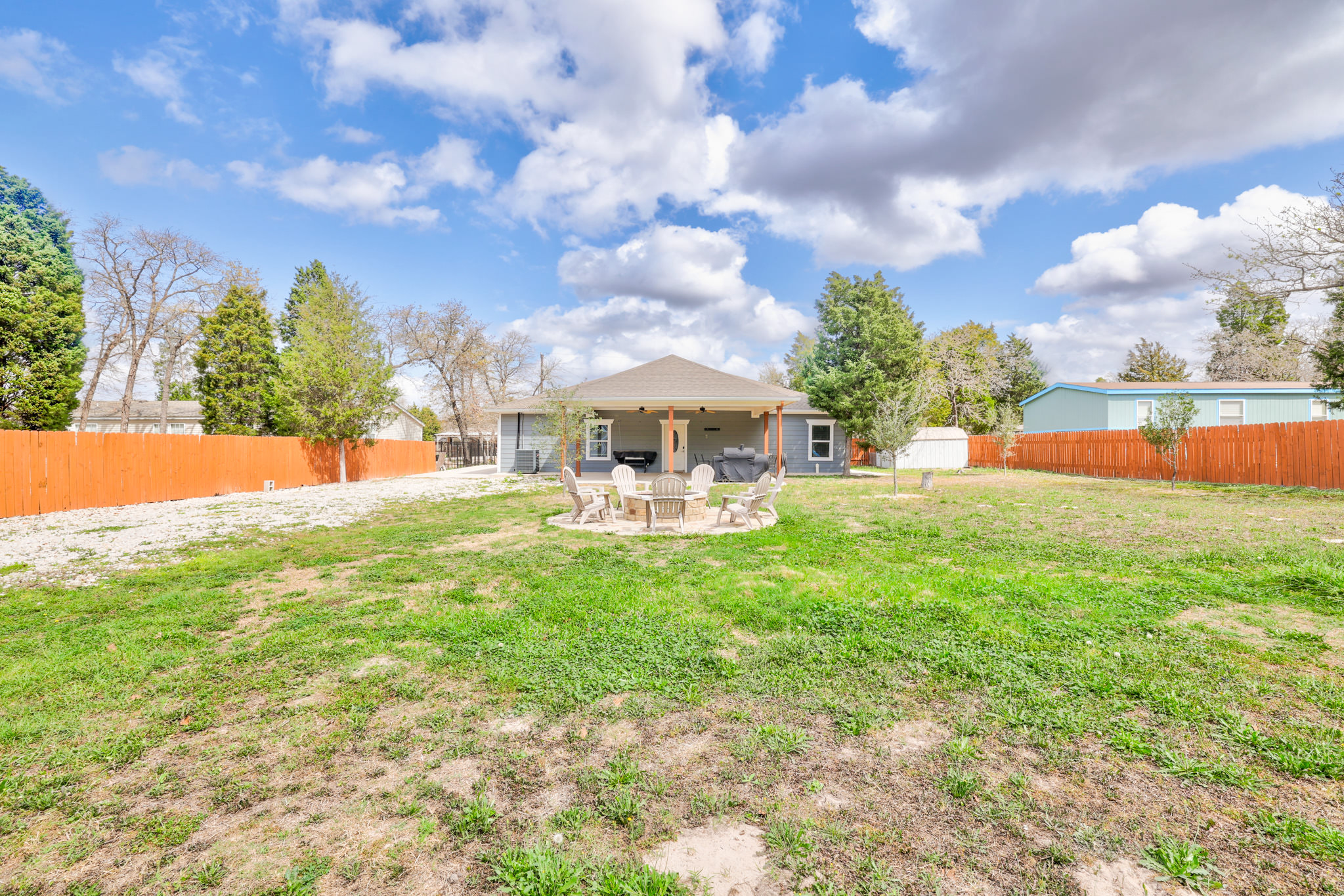 421 Las Lomas Drive Elgin, TX 78621 - Photo 3 of 30 Back of property featuring a fenced backyard and a patio area