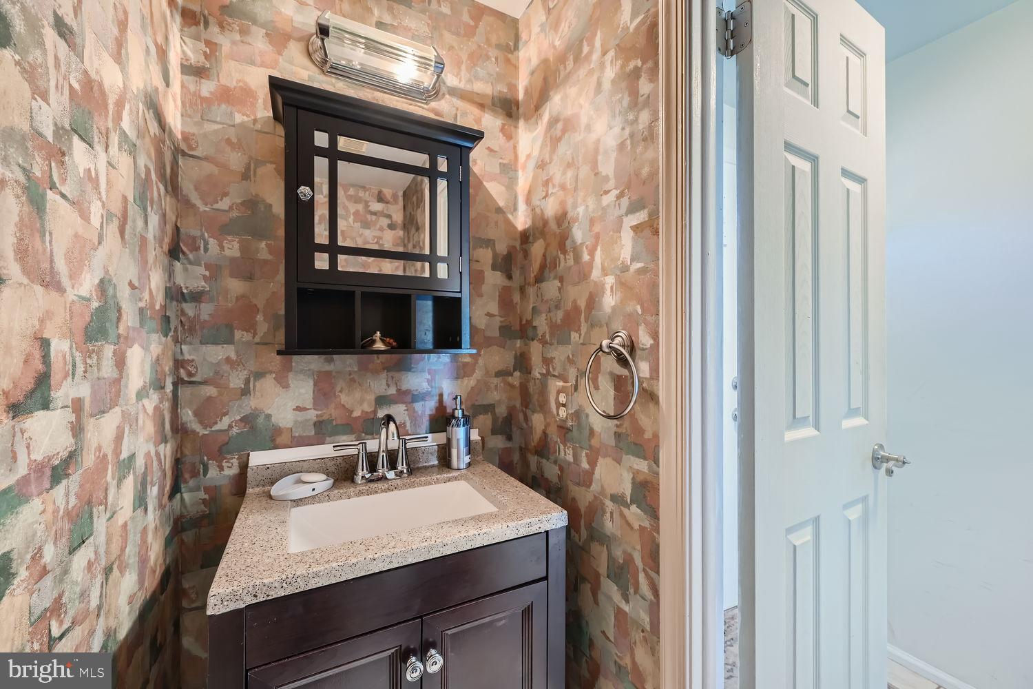 5435 King Arthur Circle Rosedale, MD 21237 - Photo 16 of 28 Charming half-bath with textured wall design.