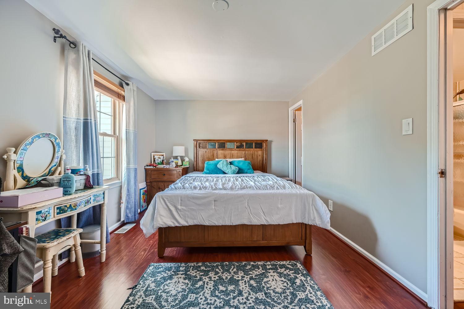 5435 King Arthur Circle Rosedale, MD 21237 - Photo 17 of 28 Serene bedroom with warm wooden accents.