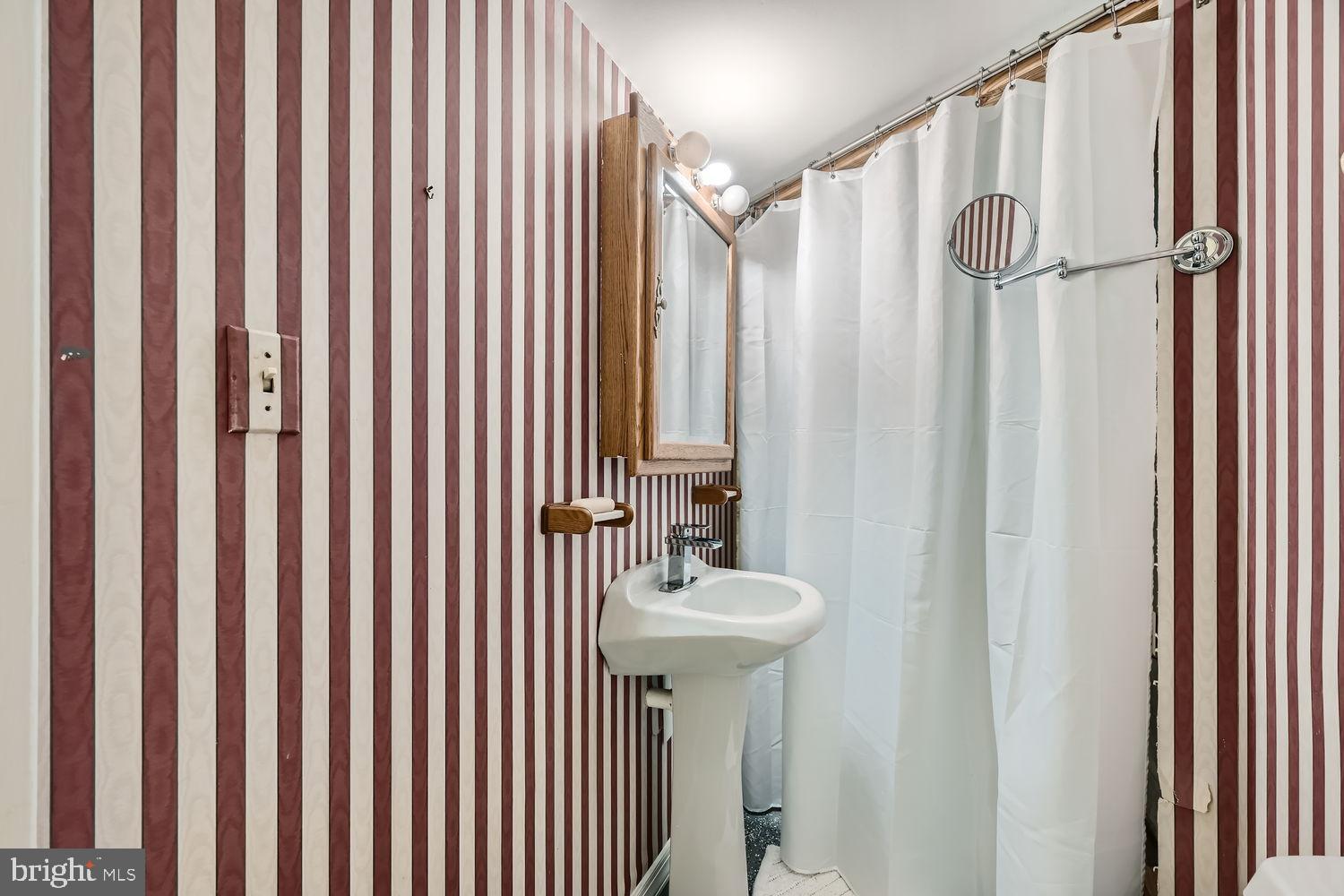 5435 King Arthur Circle Rosedale, MD 21237 - Photo 24 of 28 Charming striped bathroom with vintage flair.