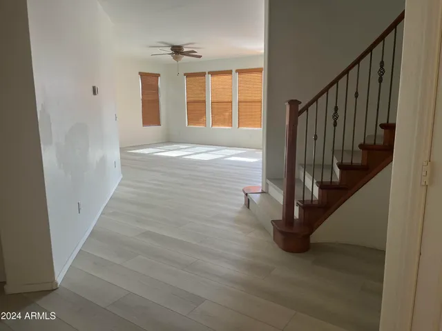 a view of entryway with wooden floor and front door