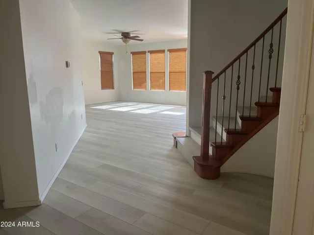 a view of entryway with wooden floor and front door
