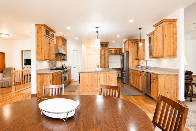1055 North 1000 East Mapleton, UT 84664 - Photo 31 of 112 Bright kitchen featuring wood-finish cabinetry, stainless steel appliances, a central island with countertop, and recessed lighting