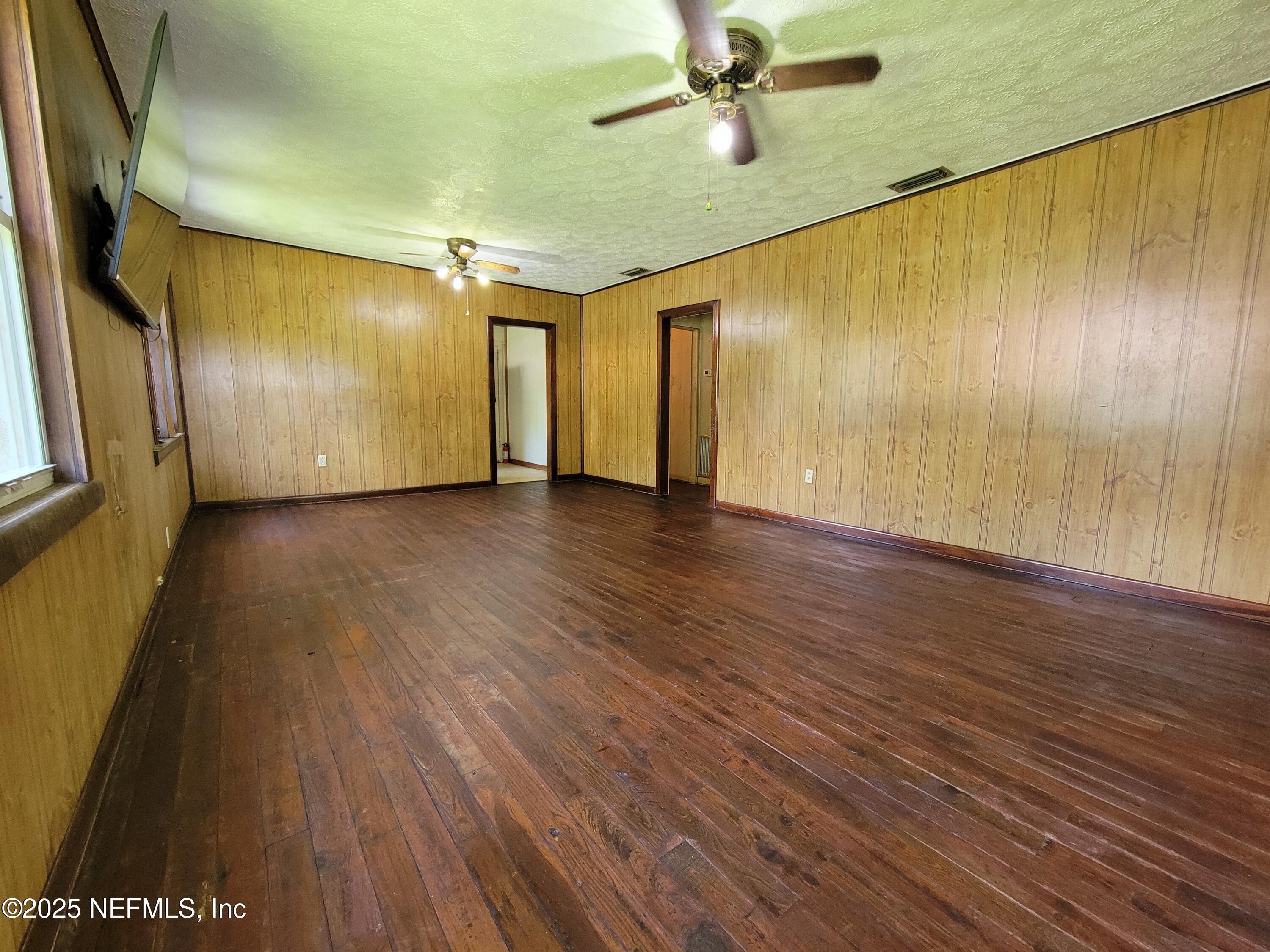 762 North Walnut Street Starke, FL 32091 - Photo 14 of 38 a view of an empty room with wooden floor