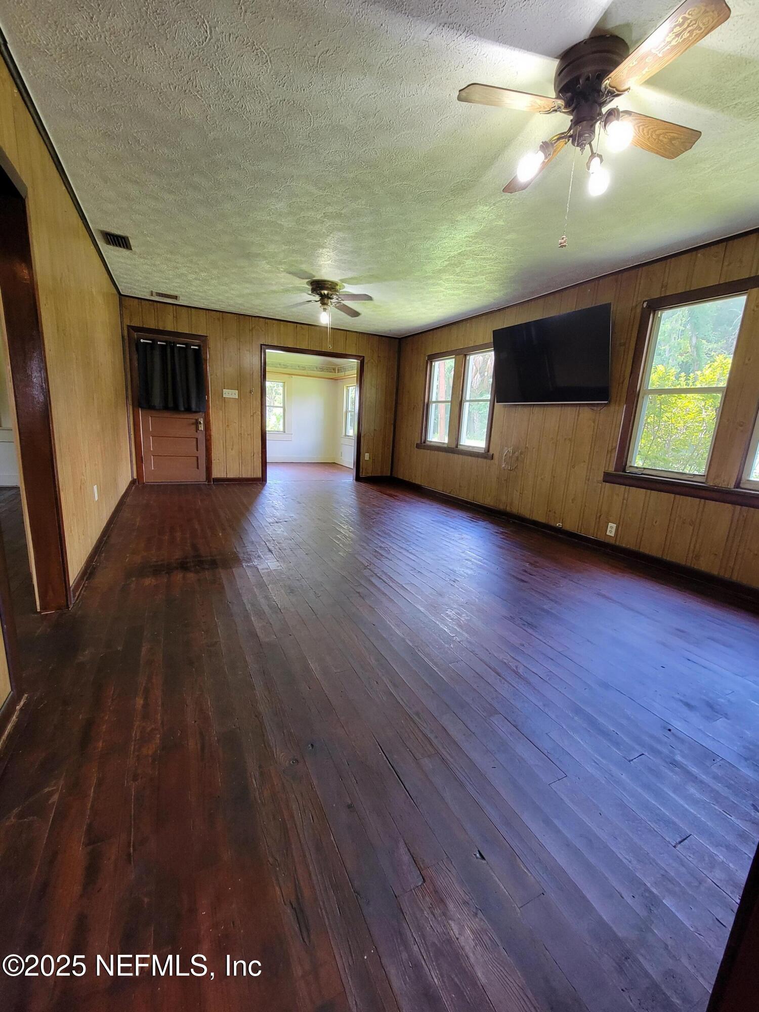 762 North Walnut Street Starke, FL 32091 - Photo 15 of 38 a view of a livingroom with hardwood floor and a ceiling fan
