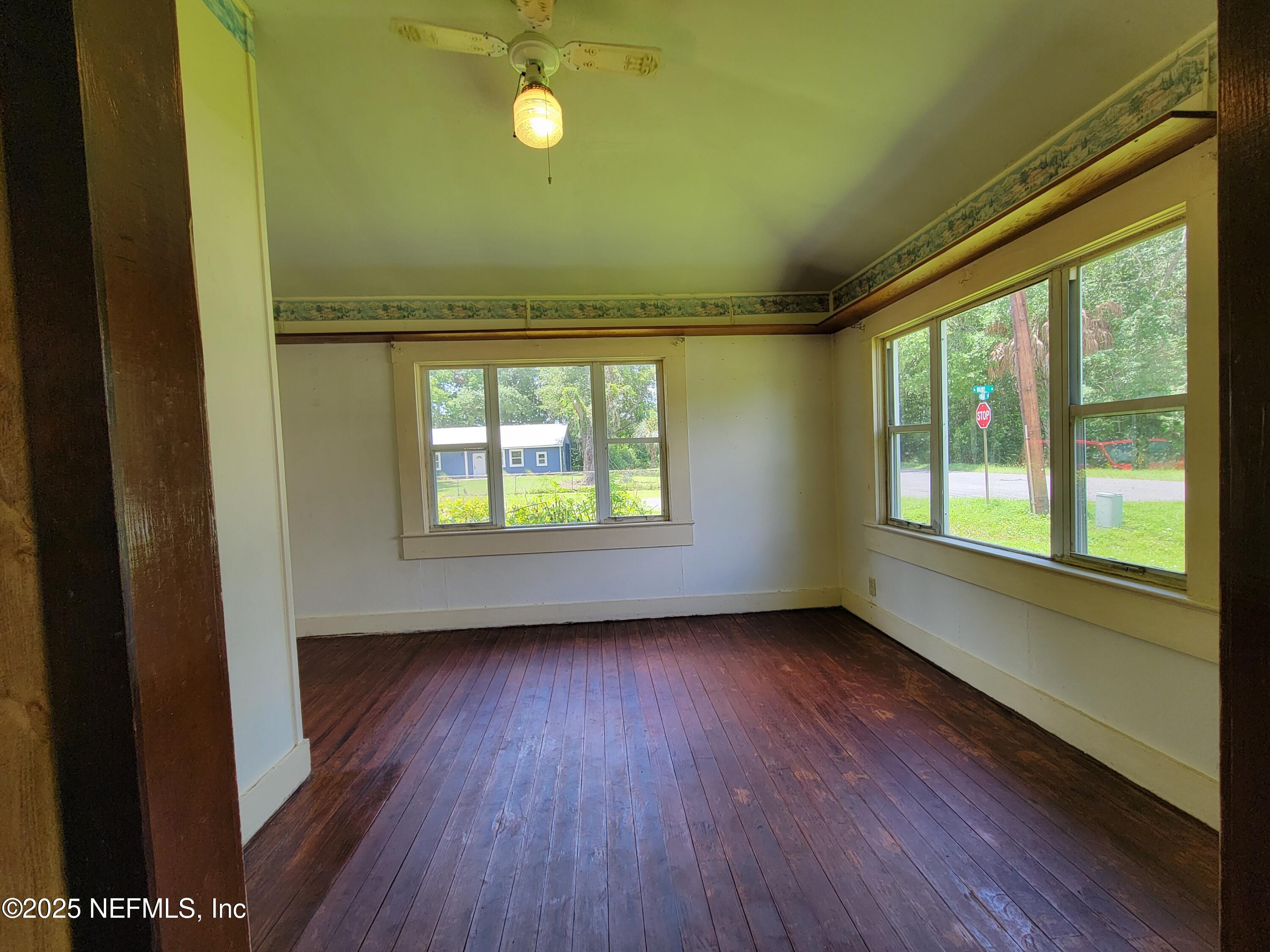762 North Walnut Street Starke, FL 32091 - Photo 16 of 38 a view of an empty room with a window and wooden floor