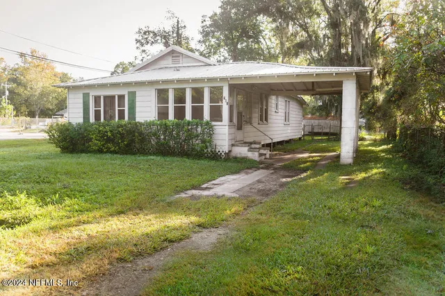 a view of a house with backyard and garden