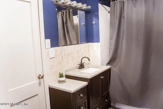 a bathroom with a sink a mirror and a bathtub
